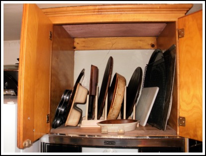 Organizing stoneware and pans.