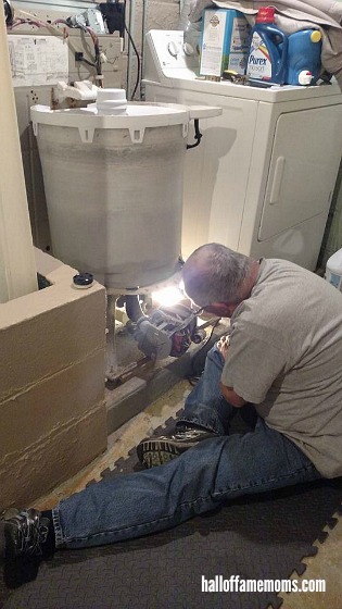 Repairman fixing broken washing machine.