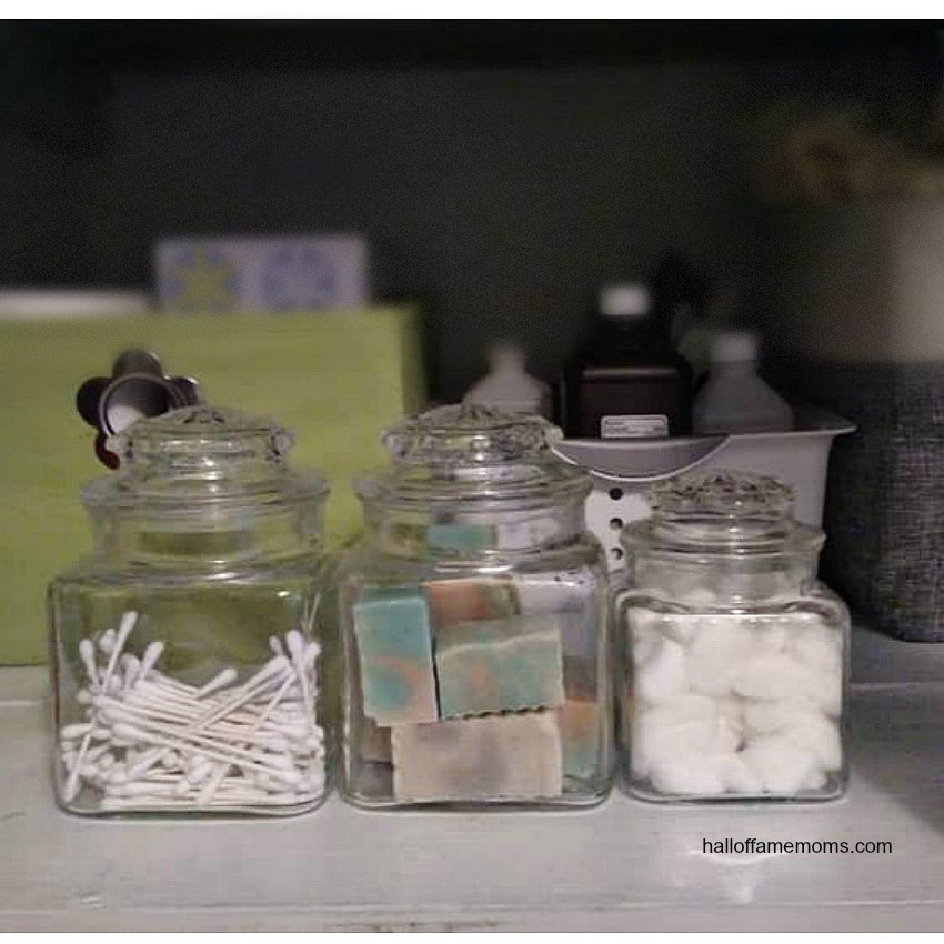 Organizing my linen closet with vintage jars.